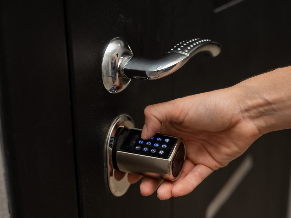 Woman opens the combination lock on the door to the apartment. Keyless entry.